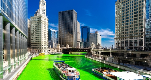 Chicago Skylines building along green dyeing river of Chicago River on St. Patrick's day festival in Chicago Downtown IL USA