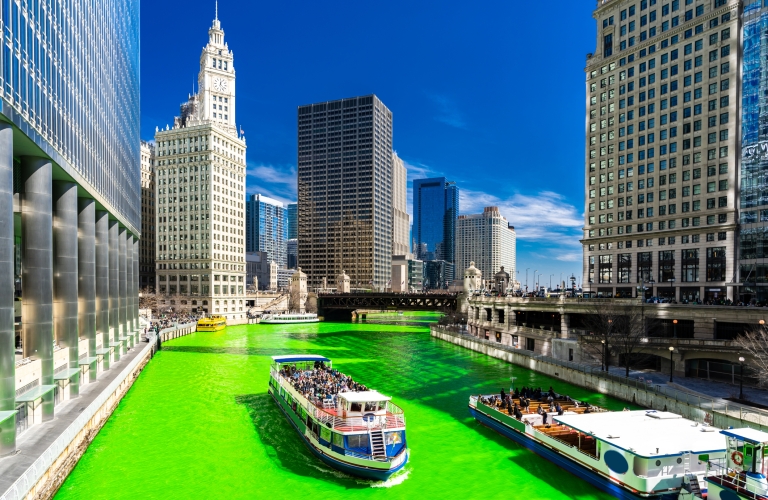 Chicago Skylines building along green dyeing river of Chicago River on St. Patrick's day festival in Chicago Downtown IL USA